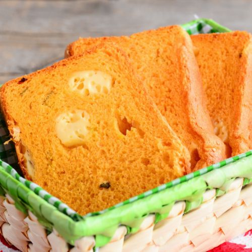 A serving plate with three slices of pumpkin bread