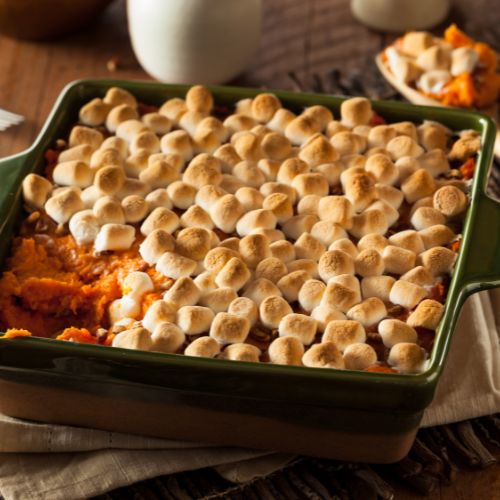 A dish of sweet potato casserole with marshmallows