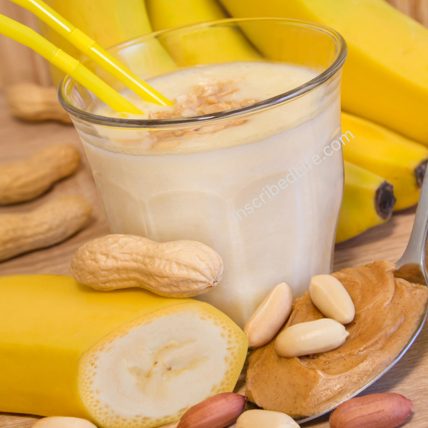 A banana smoothie with bananas and peanuts around