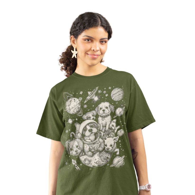 A woman smiling and wearing the Dogs in Space Graphic Tee in Military Green