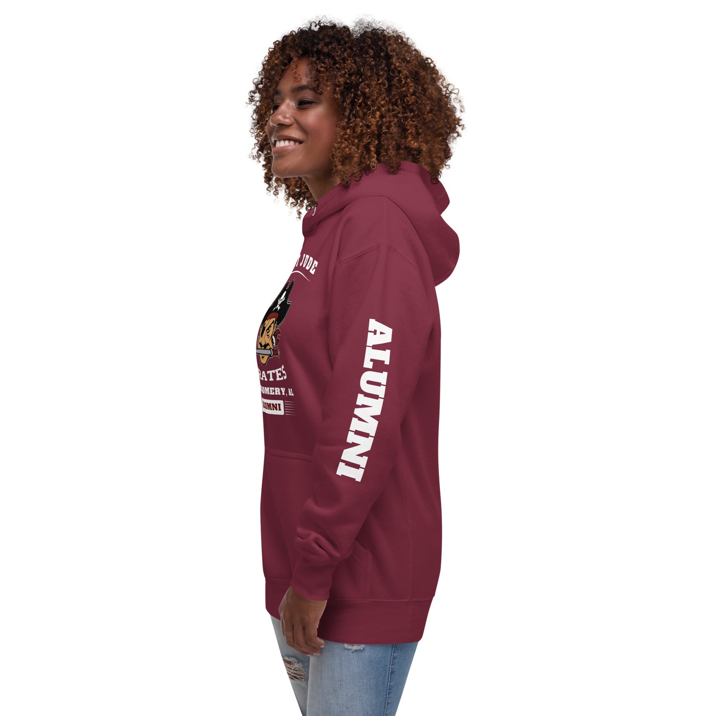 A lady standing with her left arm to the camera wearing the Saint Jude High School Hoodie and the sleeve reads, "Alumni"