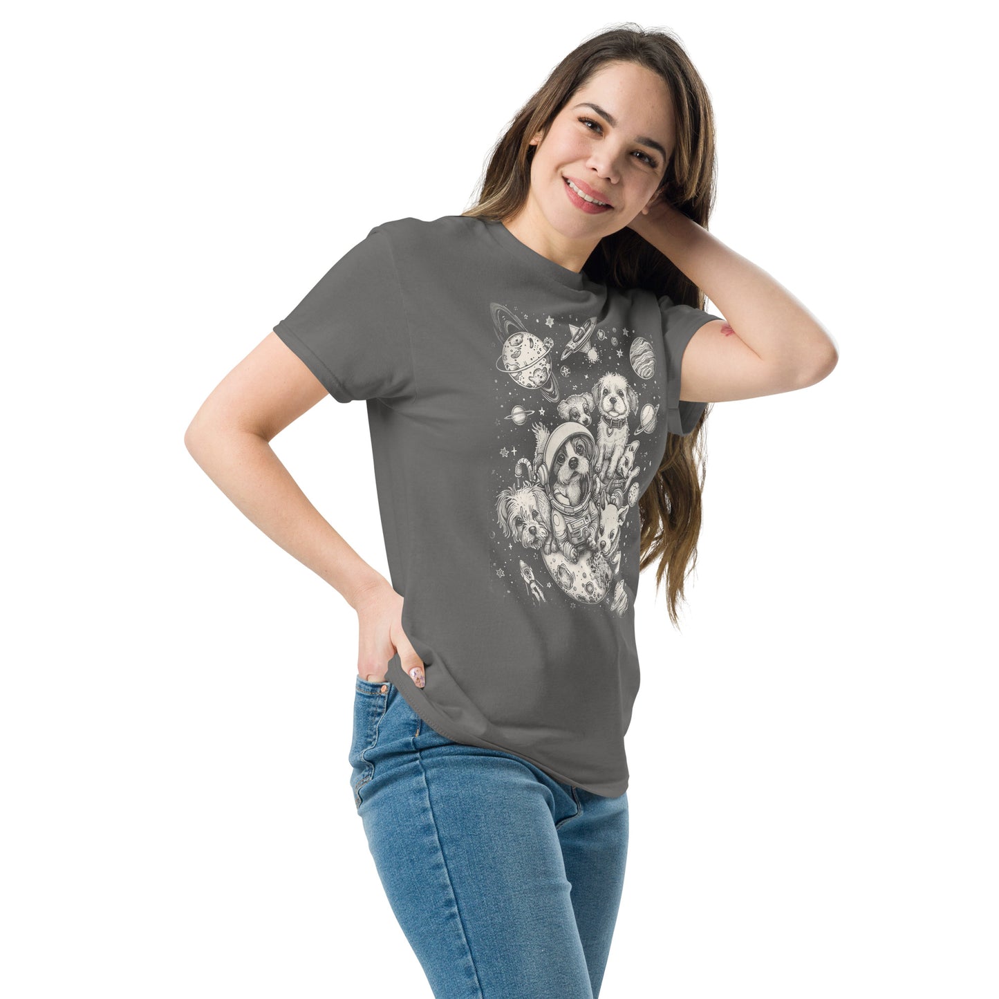 A woman smiling, standing at an angle, and wearing the Dogs in Space Graphic Tee Shirt in charcoal gray with her hand behind her head