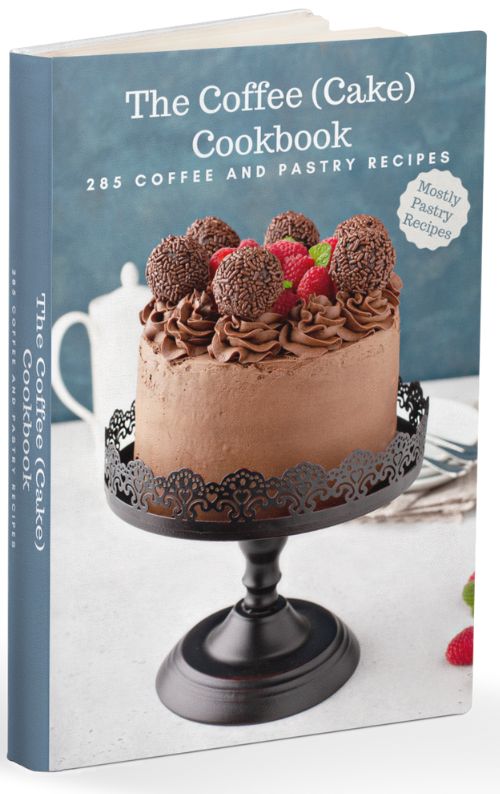 A mockup of the Coffee (Cake) Cookbook eBook displaying a cake on a pedestal on a white surface with a small pitcher in back, all against a blue background